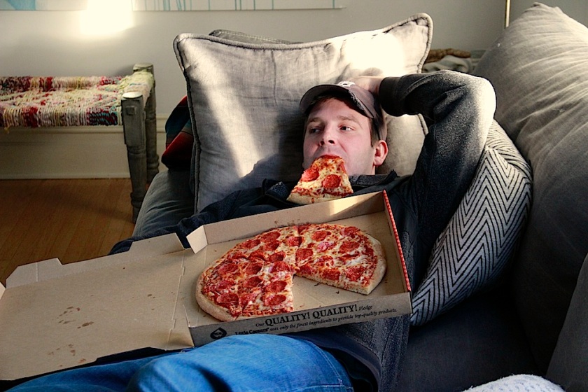 eating pizza in front of the TV